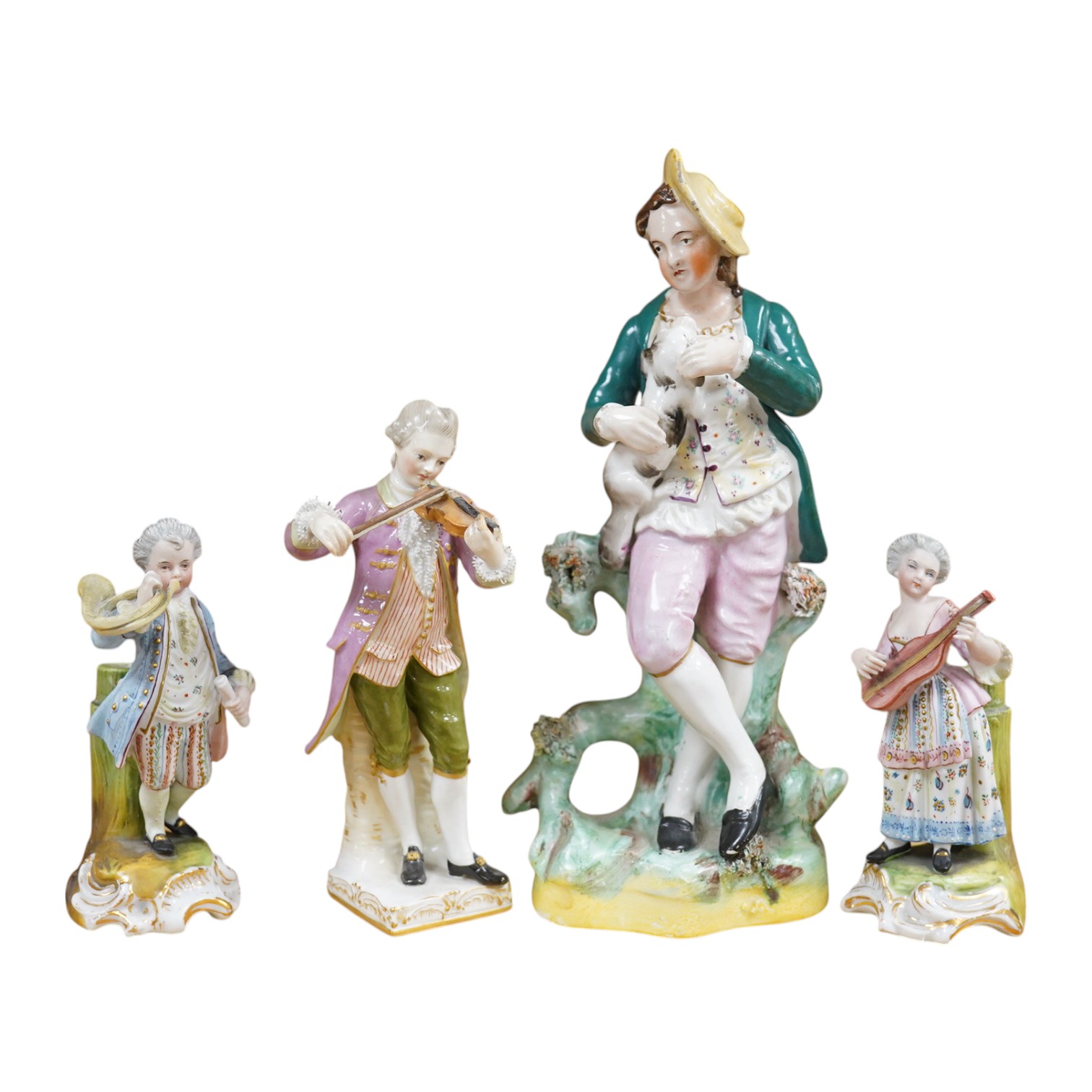 A mid 19th century Staffordshire figure wearing a green jacket, a Berlin KPM figure of a violinist and two coloured biscuit musicians, tallest 23cm. Condition - fair to good